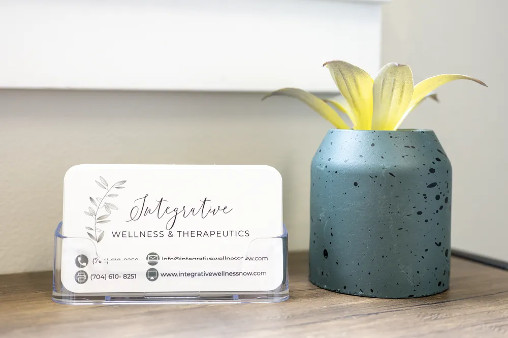 Integrative Wellness and Therapeutics business cards at the front desk