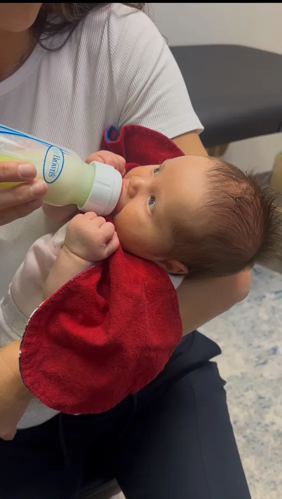 Therapist supporting an infant during a bottle feeding therapy session
