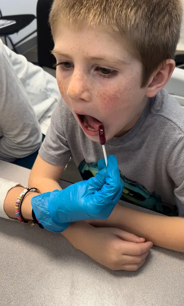 Child working on oral motor skills with a therapist