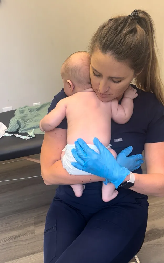 Therapist holding an infant during an infant therapy session