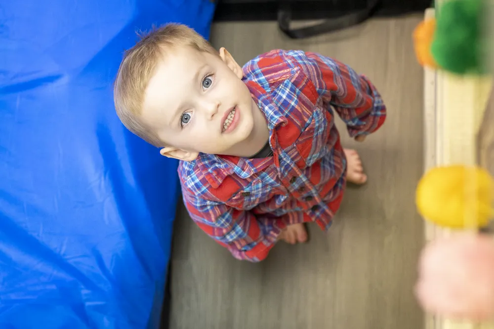 Toddler looking up and smiling in the sensory gym