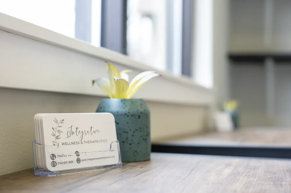 Integrative Wellness & Therapeutics business cards on the clinic's front desk